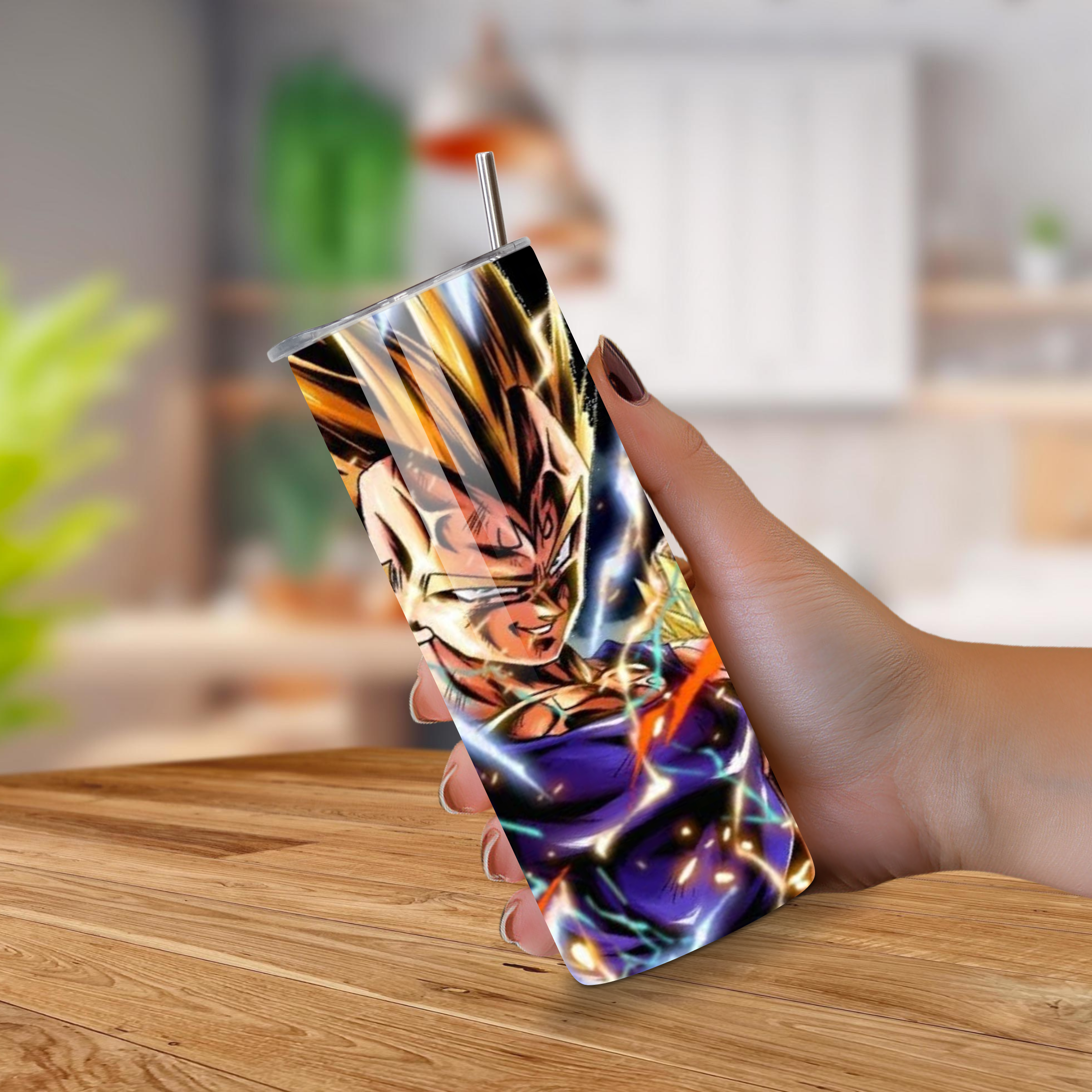 Hand holding a colorful tumbler with a Vegeta design on a wooden surface.