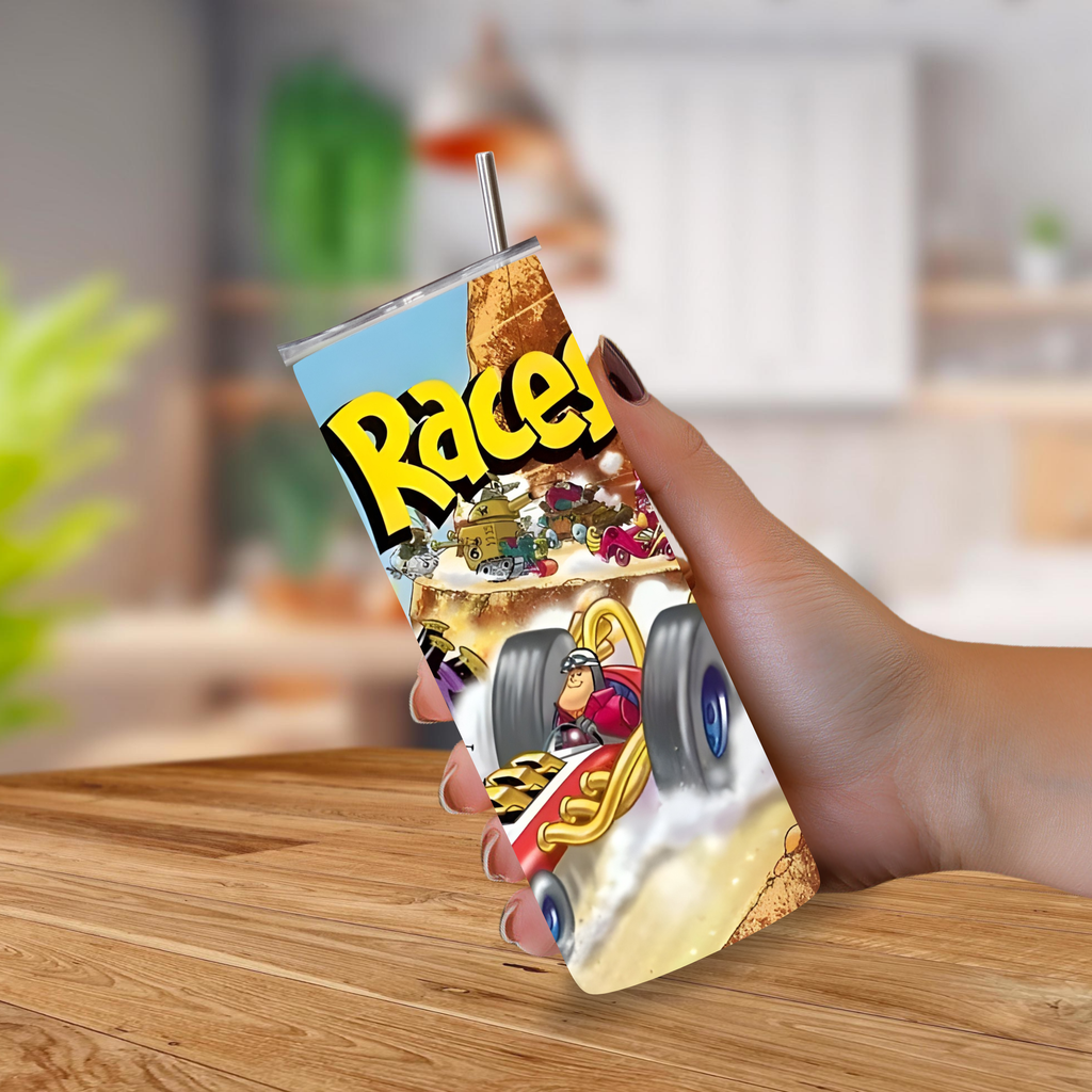 A hand holding a slim 20oz tumbler with a metal straw, featuring a colorful cartoon graphic of a race car and the word 'Wacky Races' in bold yellow letters, set against a blurred kitchen background.