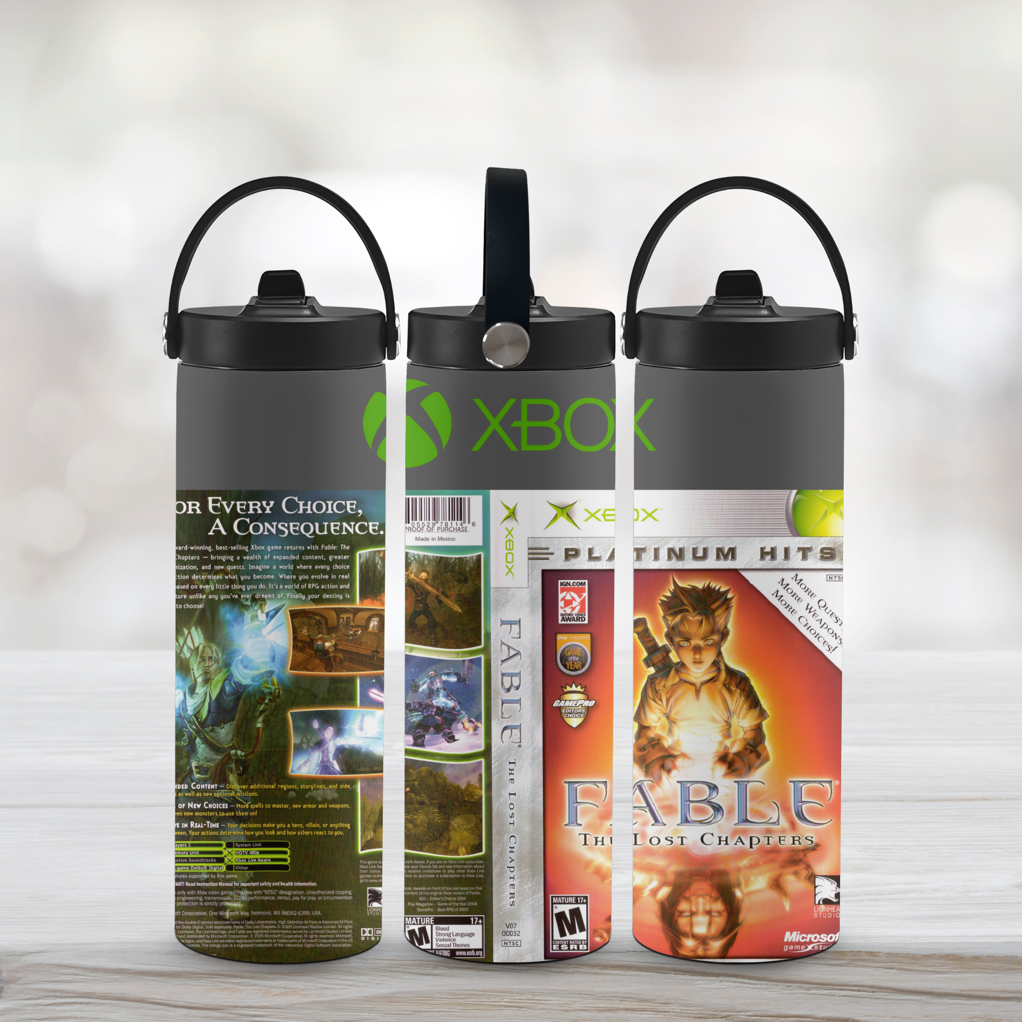 Three water bottles with Xbox Fable gaming-themed labels on a wooden surface.
